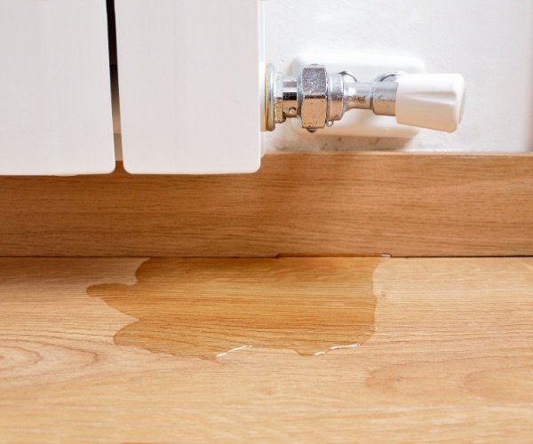 Wasserschaden am Holzboden durch eine undichte Leitung